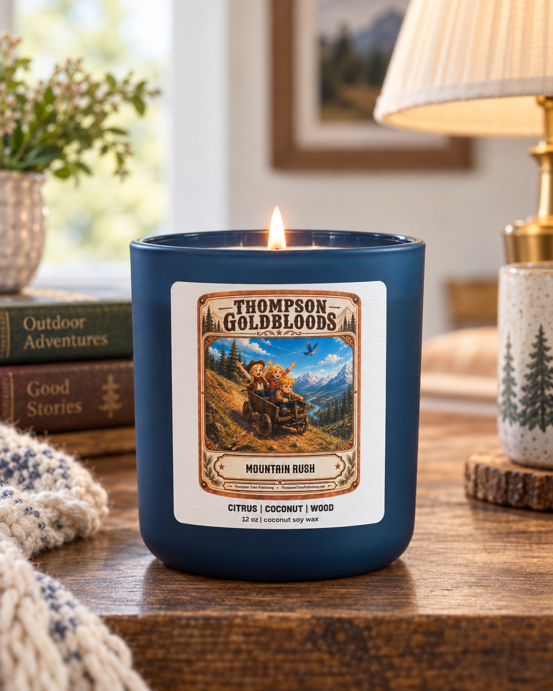 Mountain Rush candle in blue vessel, lit, lifestyle shot